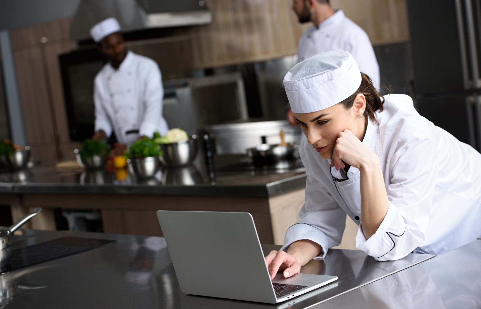 Chef using laptop in a kitchen