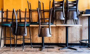 Chairs and Stools Stacked on Tables in an Empty Closed Restaurant